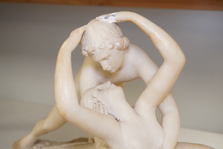 An alabaster figural carving of Cupid and Psyche, 28cm high, 45cm wide. Condition - poor to fair, some damage particularly to her hand, Cupid’s wings missing, etc.